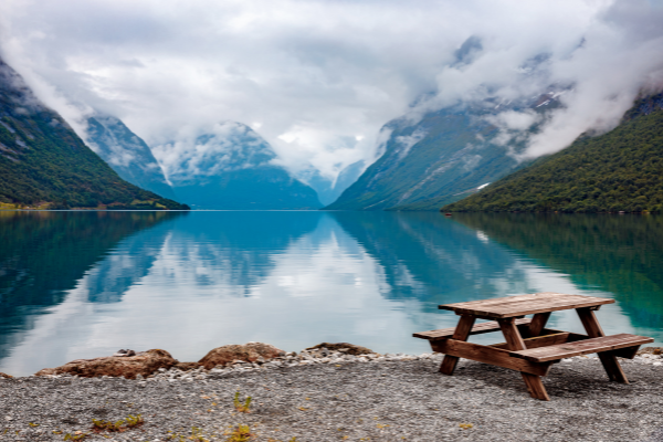 lake with wooden bench on shore